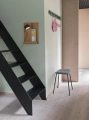 14755-en-coil-coat-rack-100-dark-green-fiber-stool-tube-black-st-trio-153-folded-burnt-orange-post-wall-muuto-org.webp