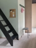14755-en-coil-coat-rack-100-dark-green-fiber-stool-tube-black-st-trio-153-folded-burnt-orange-post-wall-muuto-org.webp
