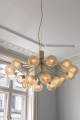 nuura-apiales-18-chandelier-flower-inspiration-brass-optic-light-aw22.jpg.webp