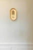 nuura-sasi-small-brass-wall-lamp-mirror-reflections.jpg.webp
