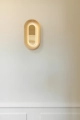 nuura-sasi-small-brass-wall-lamp-mirror-reflections.jpg.webp