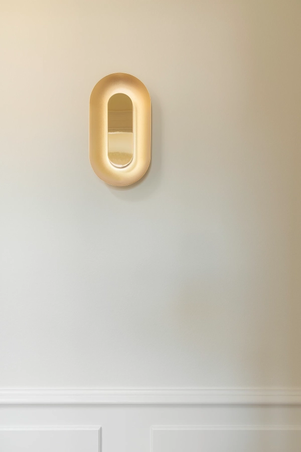 nuura-sasi-small-brass-wall-lamp-mirror-reflections.jpg.webp