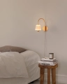 Nuura_Asteea_Wall_Satin_brass_-_rippled_clear_lifestyle_2.jpg.webp