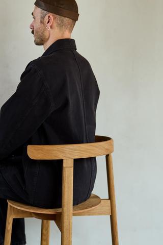 Form and Refine_Lunar-chair-Oak-wooden-seat_man-seating.jpg